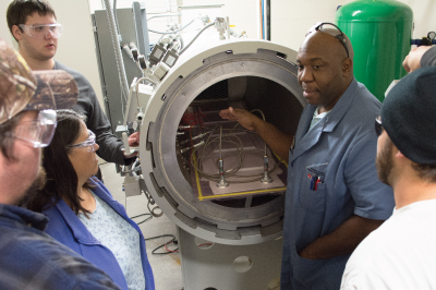 Instructor showing students an autoclave